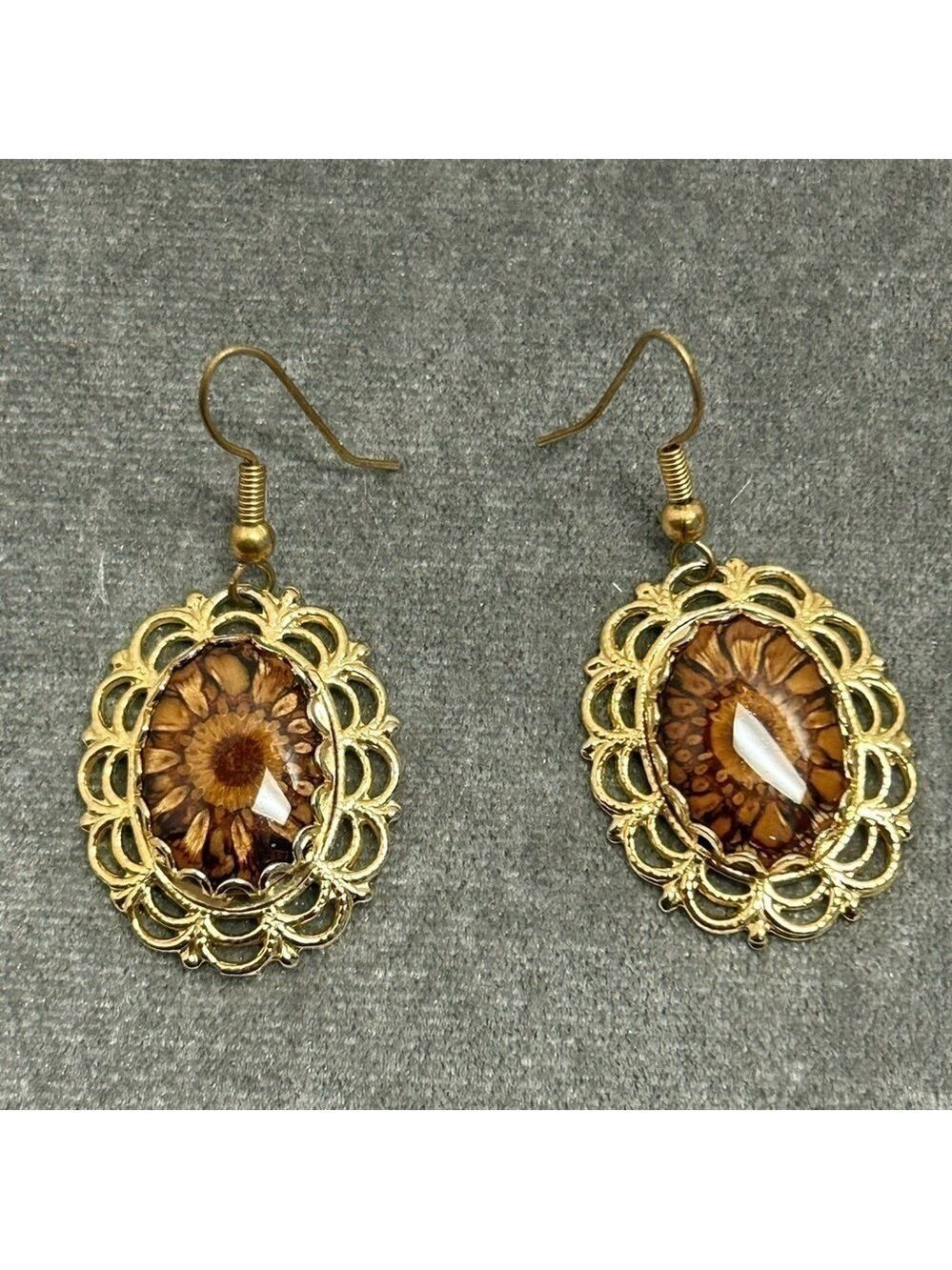Gold tone flower cat eye oval dangling earrings